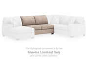 Ashley Furniture Newellen sectional with chaise, showing a modern fabric sofa with a spacious chaise lounge in a living room setting.