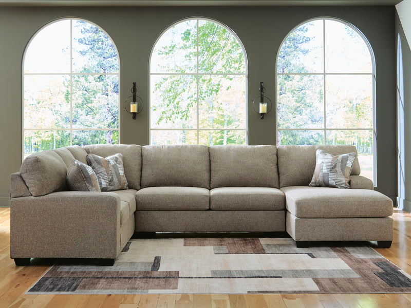 Ashley Furniture Newellen sleeper sectional with chaise, featuring plush upholstery and a modern design, shown in a cozy living room setting.