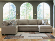 Ashley Furniture Newellen sectional with chaise, featuring plush cushions and modern design, shown in a cozy living room setting.