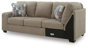 Ashley Furniture Newellen sectional with chaise, showing plush fabric upholstery and modern design from a side angle.