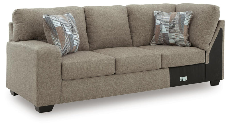 Ashley Furniture Newellen sectional with chaise, showing plush fabric upholstery, modern design, and spacious seating arrangement.
