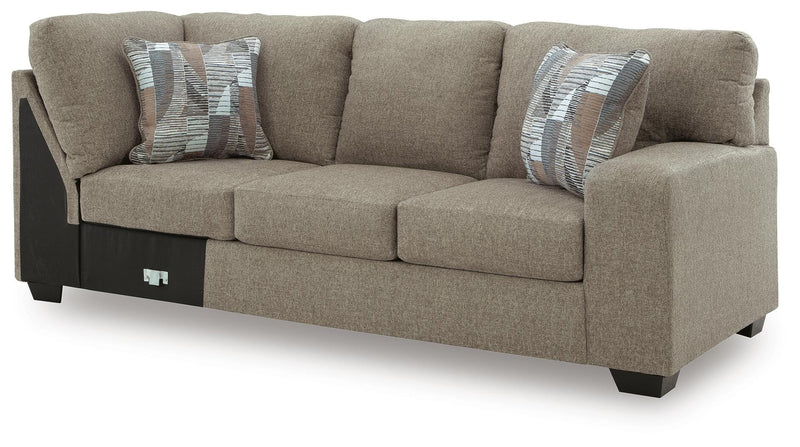 Ashley Furniture Newellen Sleeper Sectional with Chaise, angled view showing plush cushions and modern design.