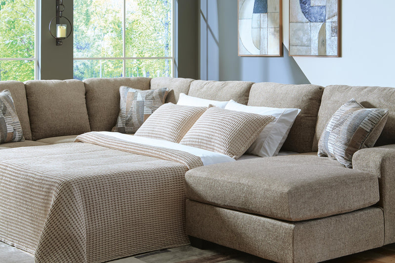 Ashley Furniture Newellen Sleeper Sectional with Chaise, beige fabric, with plush cushions and chaise lounge for relaxing comfort.