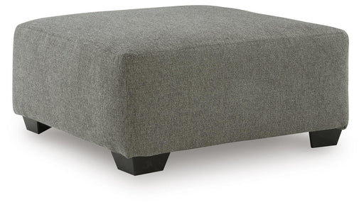 Ashley Furniture Clarington oversized accent ottoman with plush fabric and a tufted top, shown from an angled view.