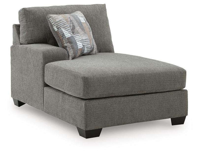 Ashley Furniture Clarington Super Chaise sectional in neutral fabric, featuring plush cushions and modern design, viewed from an angle.