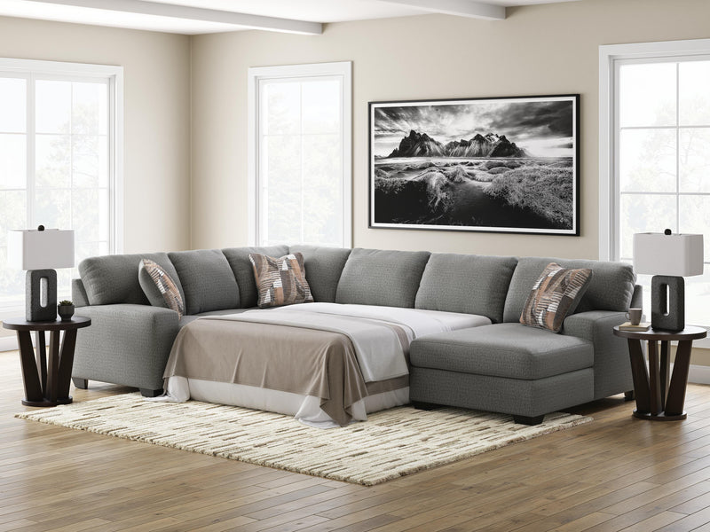 Ashley Furniture Clarington Sleeper Sectional with Chaise, beige fabric, modern design, includes a pull-out bed and spacious chaise lounge.