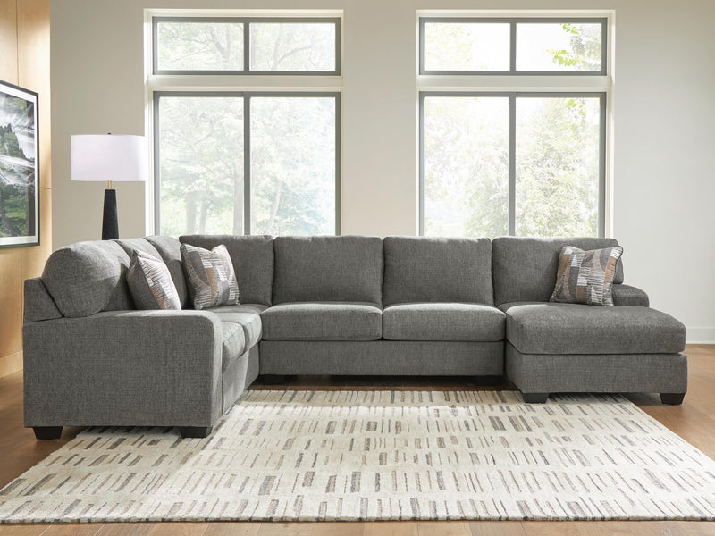 Ashley Furniture Clarington sectional with chaise, featuring plush cushions and a modern design in a neutral fabric.