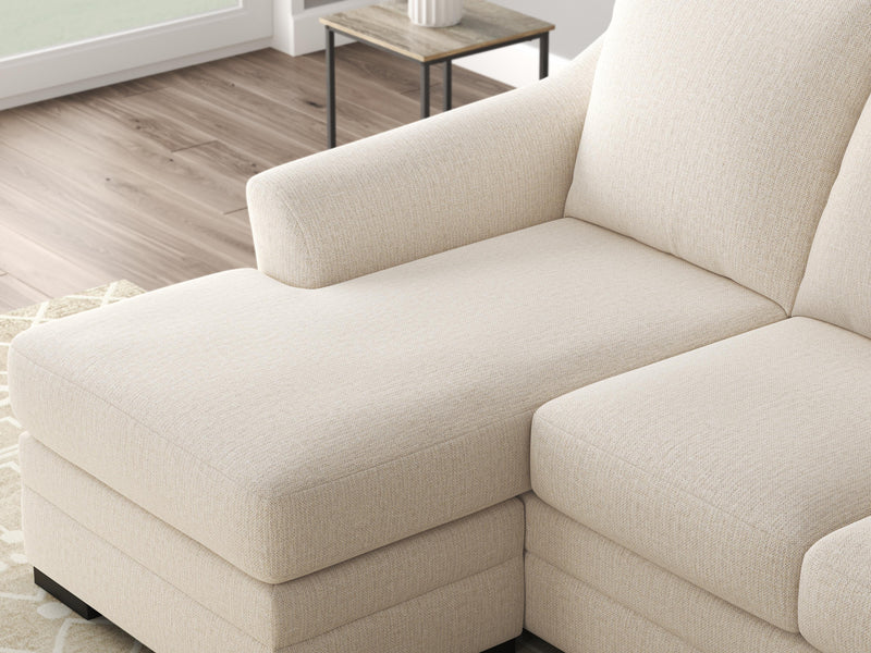 Ashley Furniture Lango Sofa Chaise in beige fabric, showing the detailed close-up of the chofa with plush cushions and modern design features.