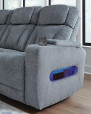 Ashley Furniture Studio Cave living room set with beige fabric sofa, loveseat, and armchair in a modern living space.