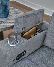 Ashley Furniture Studio Cave Power Reclining Loveseat with Console, showing armrest detail and plush fabric for comfortable seating.
