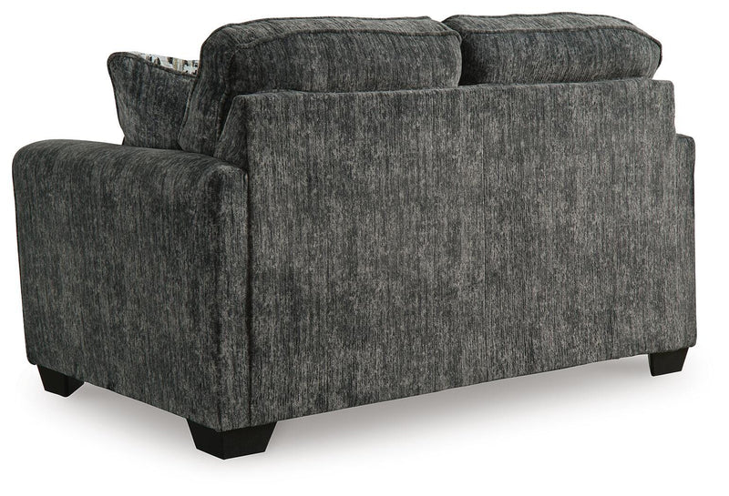 Ashley Furniture Lonoke living room set with sofa and loveseat, featuring neutral upholstery and plush cushions.