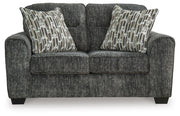 Ashley Furniture Lonoke living room set with sofa and armchair, featuring neutral upholstery and modern design.