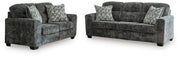 Ashley Furniture Lonoke living room set with sofa and armchairs, featuring plush beige upholstery and modern design.