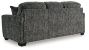Ashley Furniture Lonoke living room set with plush sofa and matching armchair, shown from the back in this image.