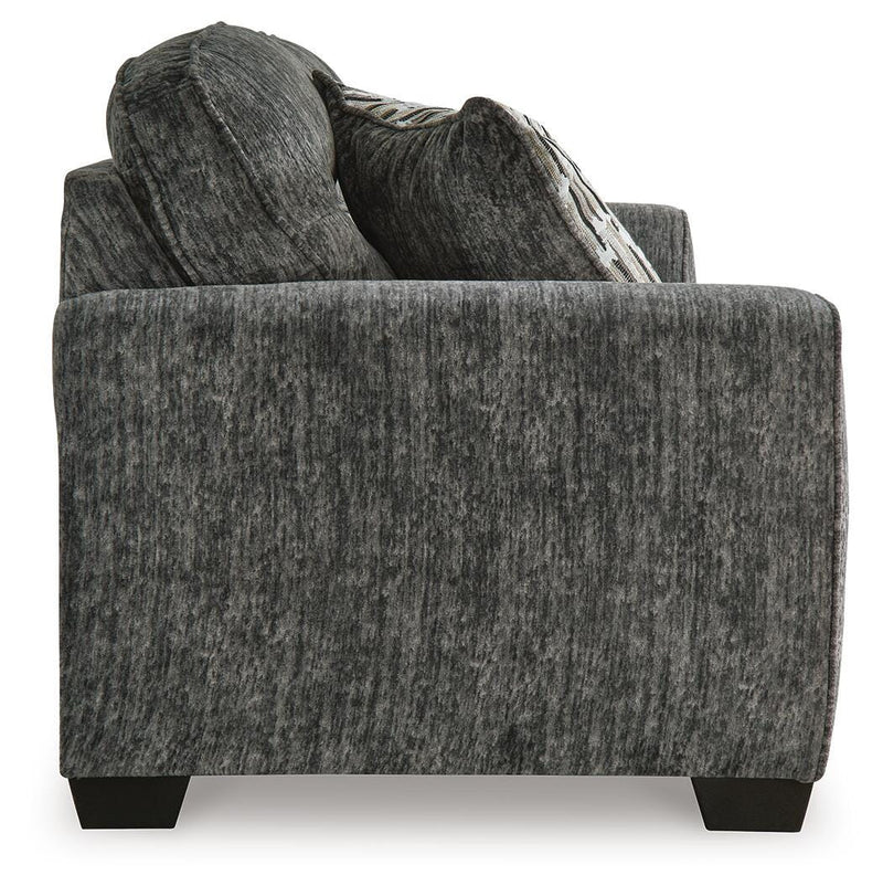 Ashley Furniture Lonoke living room set with sofa and loveseat, featuring neutral fabric upholstery and wooden legs.