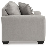 Ashley Furniture Avenal Park living room set with sofa and armchair, featuring beige upholstery and modern design.
