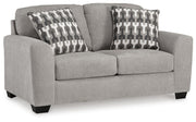 Ashley Furniture Avenal Park loveseat in neutral fabric, shown from an angled view highlighting its plush cushions and stylish design.
