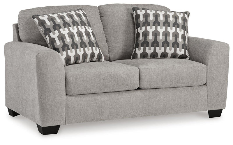 Ashley Furniture Avenal Park loveseat in neutral fabric, shown from an angled view highlighting its plush cushions and stylish design.