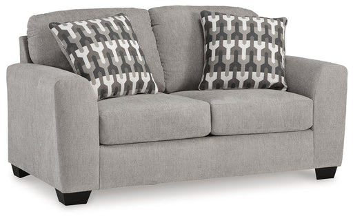 Ashley Furniture Avenal Park loveseat in neutral fabric, shown from an angled view highlighting its plush cushions and stylish design.