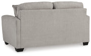 Ashley Furniture Avenal Park loveseat with plush cushions and wooden legs, shown from the back in a cozy living room setting.