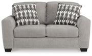 Ashley Furniture Avenal Park living room set with beige upholstered sofa and matching armchair, view from the front.