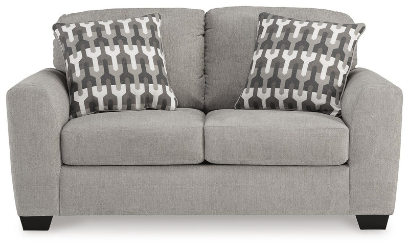 Ashley Furniture Avenal Park living room set with beige upholstered sofa and matching armchair, view from the front.