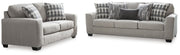 Ashley Furniture Avenal Park living room set with sofa and armchair, upholstered in dark blue fabric, in a modern living room setting.