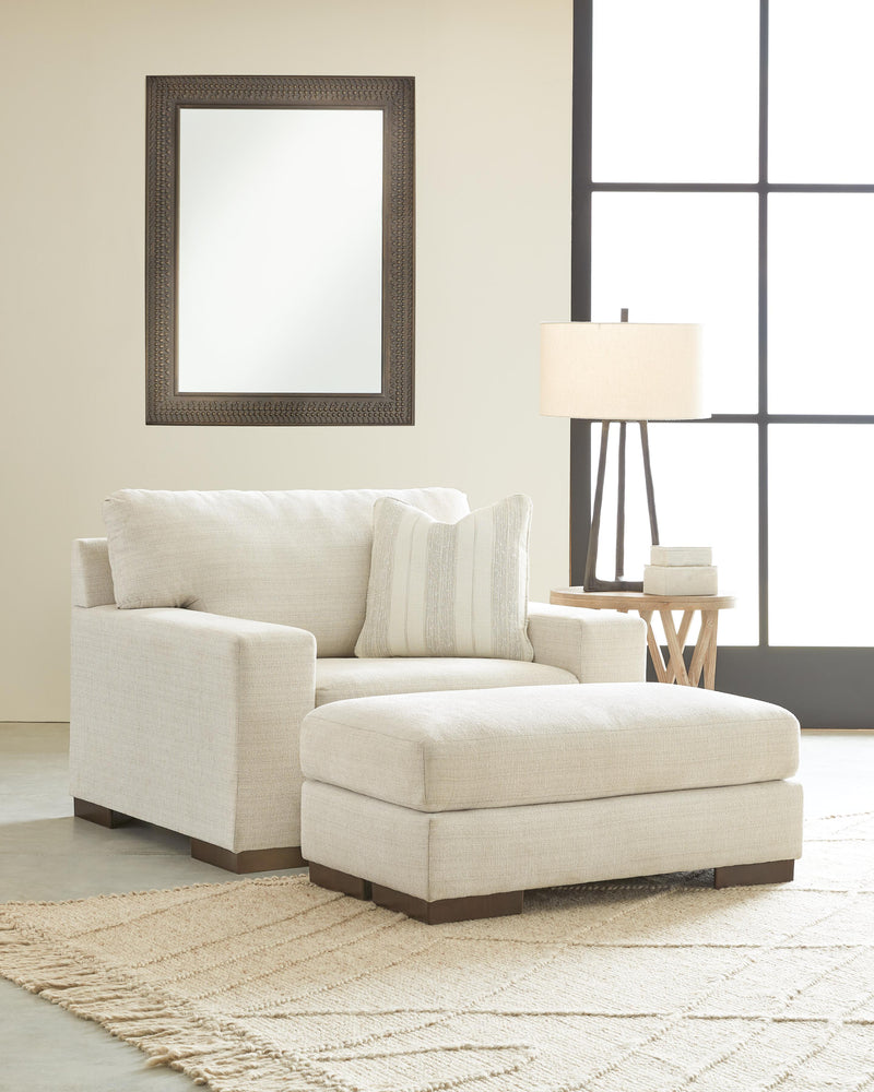 Ashley Furniture Maggie living room set with sofa and loveseat in neutral fabric, modern design with plush cushions.