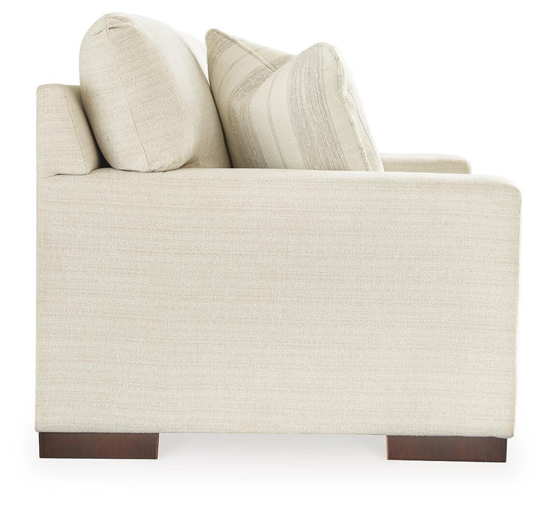 Ashley Furniture Maggie Loveseat with plush fabric and cushioned arms, showcasing a stylish and comfortable two-seat living room sofa.