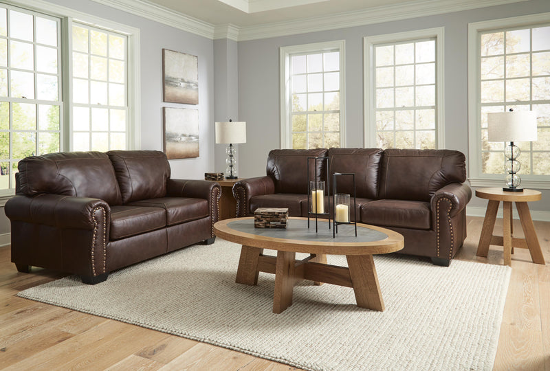 Ashley Furniture Colleton living room set with sofa, loveseat, and armchair arranged in a modern, neutral-toned family room.