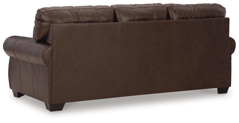 Ashley Furniture Colleton living room set shown from the back, featuring plush sofa and armchair in a cozy living space.