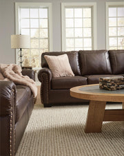 Ashley Furniture Colleton living room set with sofa and armchair in a modern design, shown in a cozy, stylish living space.