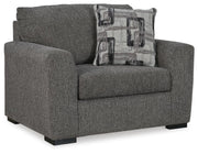 Oversized Ashley Furniture Gardiner chair with plush upholstery and wide armrests, shown from an angled side view.