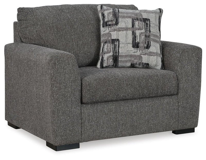 Oversized Ashley Furniture Gardiner chair with plush upholstery and wide armrests, shown from an angled side view.