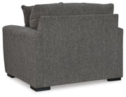 Ashley Furniture Gardiner oversized chair with plush fabric and wide armrests, shown from the back in a cozy living room setting.