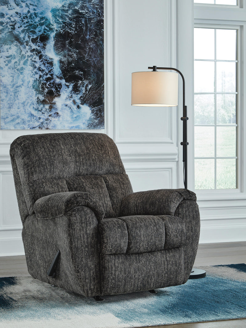 Ashley Furniture Stayfish recliner in a closed position, upholstered in neutral fabric with padded armrests and plush cushioning.