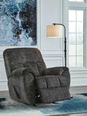 Open Ashley Furniture Stayfish recliner showing plush fabric, padded armrests, and reclining mechanism in a cozy living room setting.