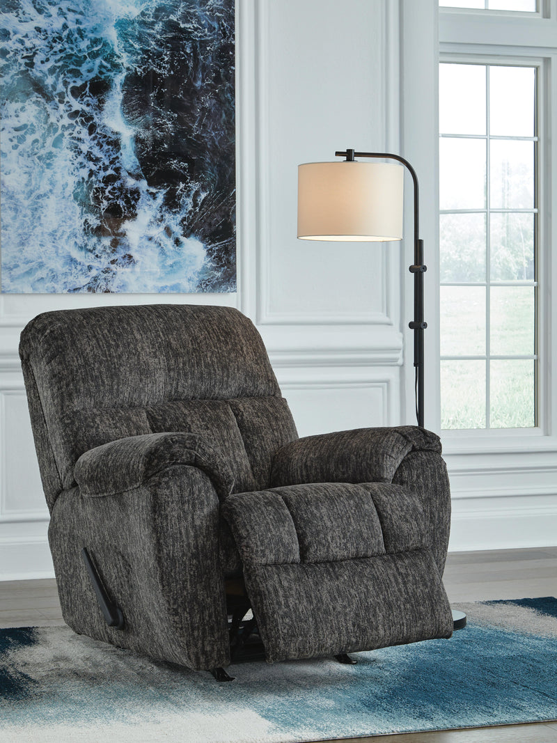 Open Ashley Furniture Stayfish recliner showing plush fabric, padded armrests, and reclining mechanism in a cozy living room setting.