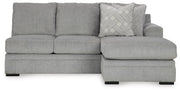 Ashley Furniture Casselbury 2-piece sectional with chaise showing plush cushions and neutral fabric in a modern living room setting.