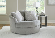 Ashley Furniture Casselbury oversized swivel accent chair with plush fabric and rounded armrests in a cozy living room setting.