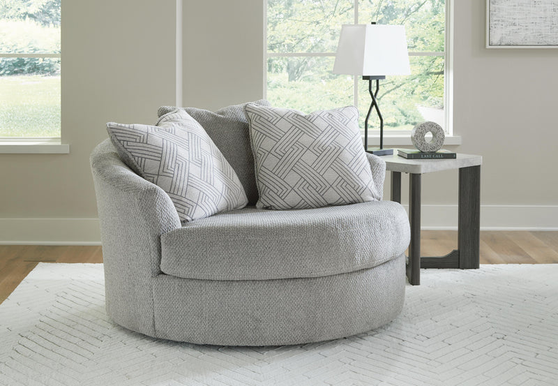 Ashley Furniture Casselbury oversized swivel accent chair with plush fabric and rounded armrests in a cozy living room setting.