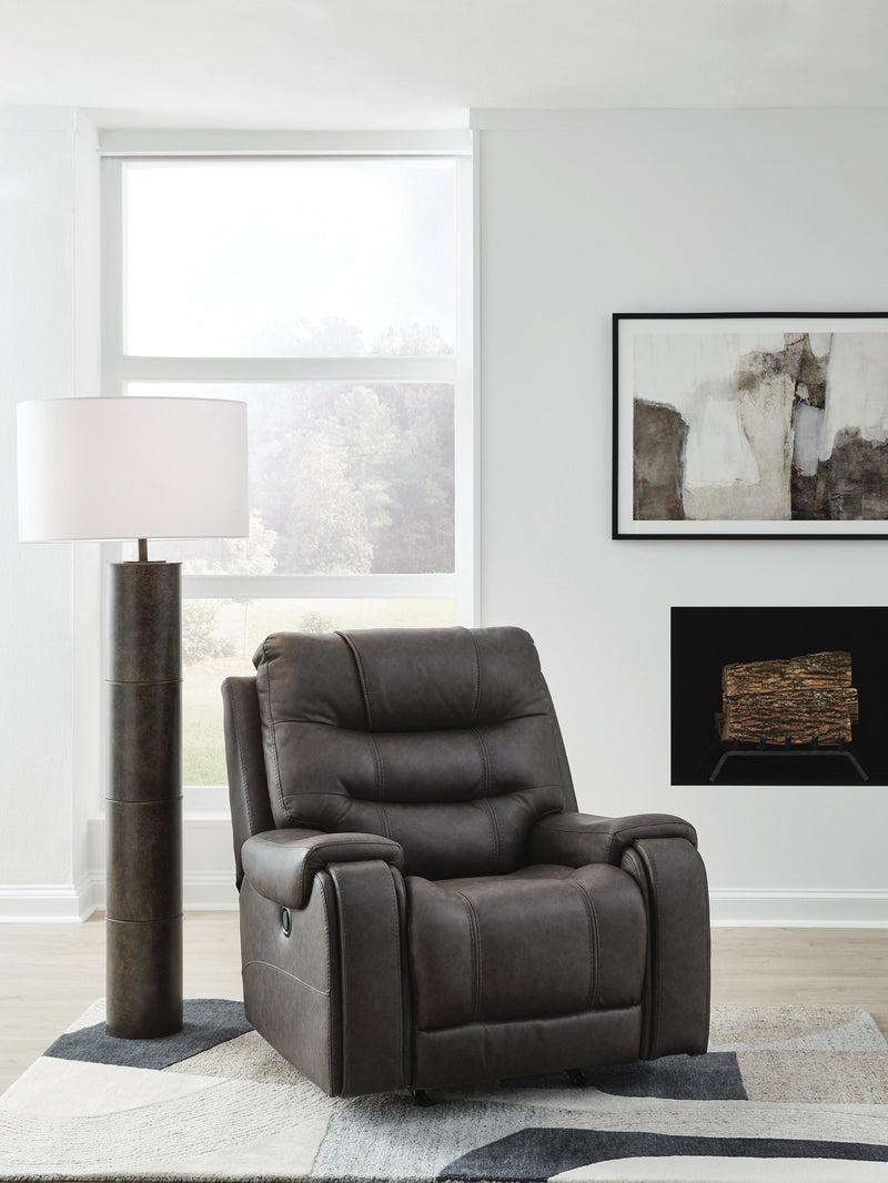 Ashley Furniture Femley recliner in dark brown fabric with plush cushioning and padded armrests, shown from a front angle.