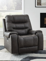 Ashley Furniture Femley recliner in neutral fabric, showing the closed, padded armrests and plush seating for comfortable lounging.
