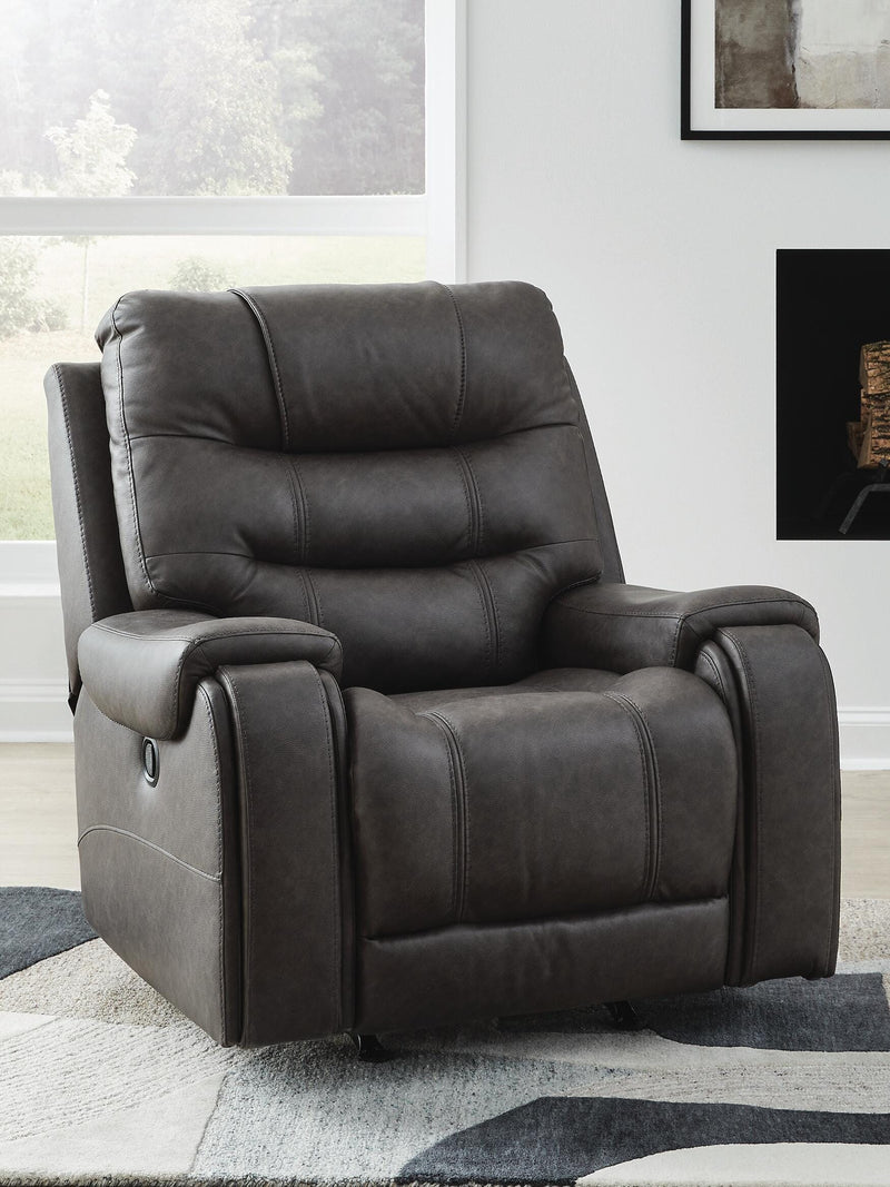 Ashley Furniture Femley recliner in neutral fabric, showing the closed, padded armrests and plush seating for comfortable lounging.