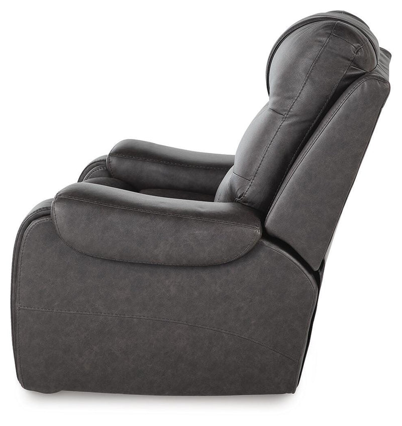 Ashley Furniture Femley recliner with plush upholstery, shown from the side in a cozy living room setting.