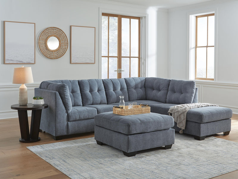 Ashley Furniture Marleton living room set with beige fabric sofa, loveseat, and armchair arranged in a modern living space.