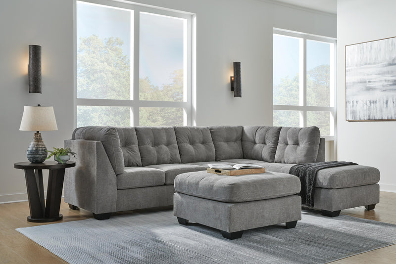 Ashley Furniture Marleton living room set with sofa and armchair, upholstered in neutral fabric, arranged in a cozy living space.