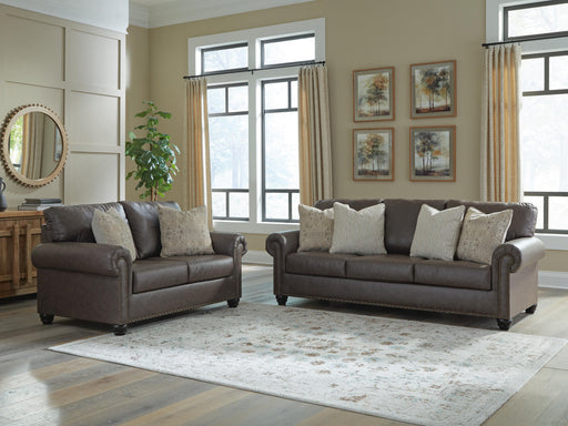 Ashley Furniture Roxmere living room set with sectional sofa and matching armchair in a modern fabric, arranged in a cozy living space.
