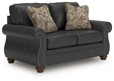 Ashley Furniture Chasemore loveseat in beige fabric, angled view showing plush cushions and wooden legs.