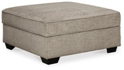 Ashley Furniture Bovarian Living Room Set with sofa and armchair, featuring neutral upholstery and modern design, shown from an angled perspective.